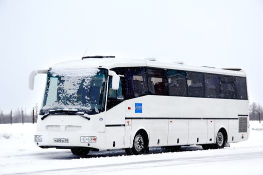 NOVYY URENGOY, RUSSIA - FEBRUARY 16, 2013: White SOR LH10.5 Arktika interurban coach covered by snow at the city street.