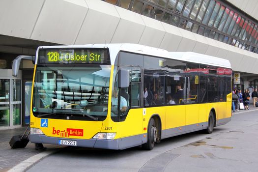 BERLIN, GERMANY - SEPTEMBER 9, 2013: Yellow Mercedes-Benz O530 Citaro LE city bus of Berliner Verkehrsbetriebe bus company at the city street.
