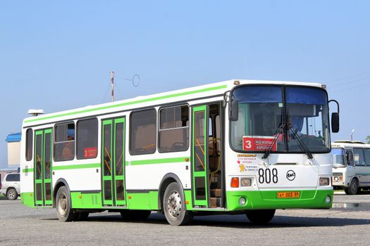 NOVYY URENGOY, RUSSIA - JULY 17, 2013: White and green LIAZ 5256 city bus at the city street.
