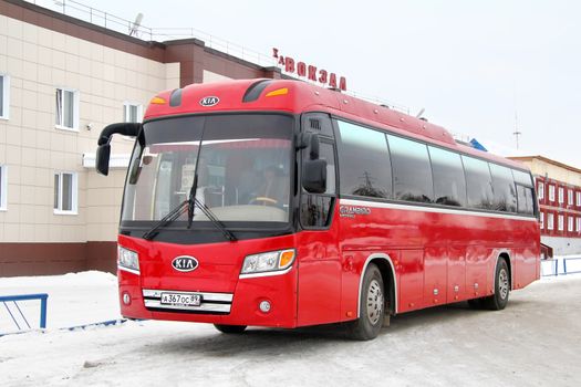 NOYABRSK, RUSSIA - OCTOBER 27, 2012: Red Kia Granbird interurban coach at the bus station.