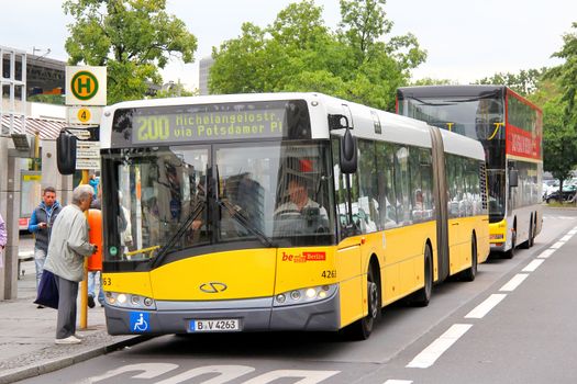 BERLIN, GERMANY - SEPTEMBER 10, 2013: Yellow Solaris Urbino 18 articulated city bus at the city street.