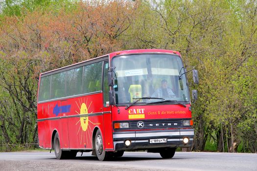 SVERDLOVSK REGION, RUSSIA - MAY 9, 2012: Red Setra S211HD interurban coach at the interurban road.