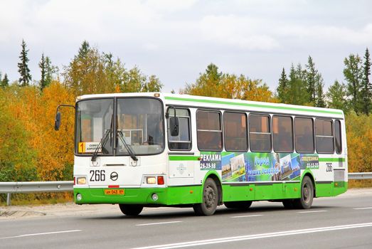 NOVYY URENGOY, RUSSIA - AUGUST 31, 2012: White and green LIAZ 5256 city bus at the city street.