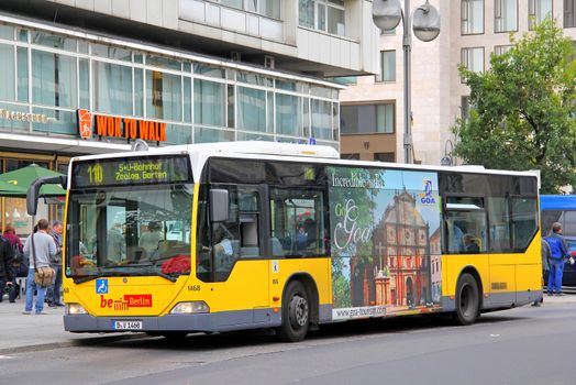 BERLIN, GERMANY - SEPTEMBER 11, 2013: Yellow Mercedes-Benz O530 Citaro city bus of Berliner Verkehrsbetriebe bus company at the city street.