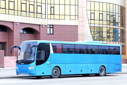 NOVYY URENGOY, RUSSIA - SEPTEMBER 22, 2012: Cyan Scania OmniExpress 340 interurban coach at the city street.