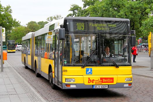 BERLIN, GERMANY - SEPTEMBER 10, 2013: Yellow MAN A23 NG313 articulated city bus of the Berliner Verkehrsbetriebe bus company at the city street.