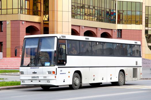 NOVYY URENGOY, RUSSIA - AUGUST 15, 2012: White MAZ 152 interurban coach at the city street.