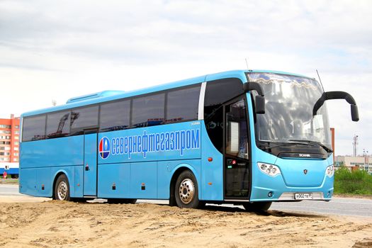 NOVYY URENGOY, RUSSIA - JUNE 24, 2014: Cyan Scania OmniExpress 340 interurban coach at the city street.