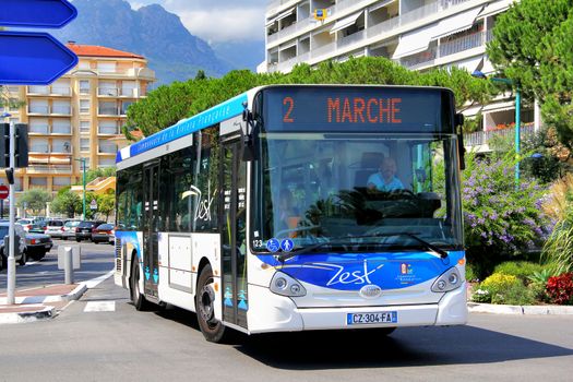 MENTON, FRANCE - AUGUST 2, 2014: White and blue Heuliez GX127 city bus at the city street.