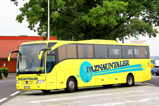 AUSTRIA - JULY 28, 2014: Yellow coach Mercedes-Benz Turk O350 Tourismo at the interurban freeway.