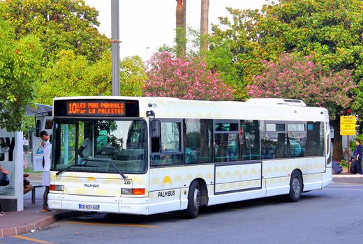 CANNES, FRANCE - AUGUST 3, 2014: White urban bus Heuliez GX317 at the bus station.