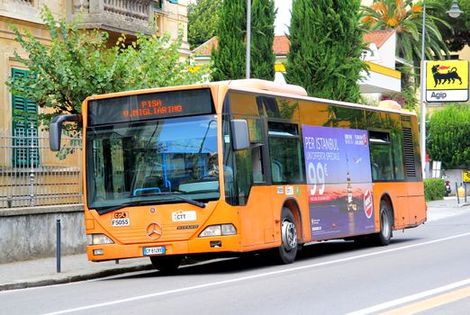 PISA, ITALY - JULY 31, 2014: Orange city bus Mercedes-Benz O530 Citaro at the city street.