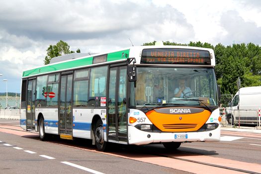 VENICE, ITALY - JULY 30, 2014: White city bus Scania OmniCity CN94UB at the city street.