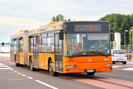 VENICE, ITALY - JULY 30, 2014: Orange articulated city bus Autodromo (MAN NG313) at the city street.