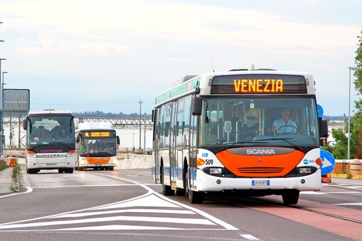 VENICE, ITALY - JULY 30, 2014: White city bus Scania OmniCity CN94UB at the city street.