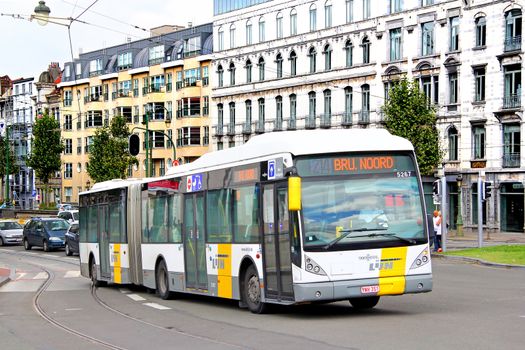 BRUSSELS, BELGIUM -  AUGUST 9, 2014: Modern articulated city bus Van Hool AG300 at the city street.