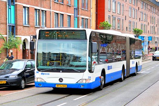 AMSTERDAM, NETHERLANDS - AUGUST 10, 2014: Modern articulated bus Mercedes-Benz O530 Citaro G at the city street.