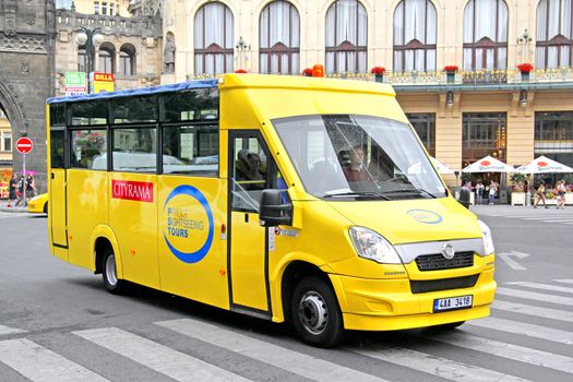 PRAGUE, CZECH REPUBLIC - JULY 21, 2014: Yellow sightseeing bus Mave (Iveco Daily) at the city street.