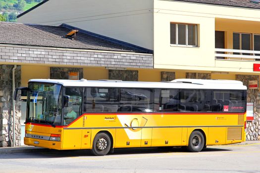 VALAIS, SWITZERLAND - AUGUST 5, 2014: Yellow suburban coach Setra S315H at the bus station.