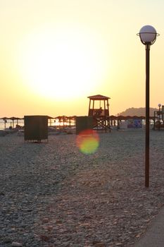 Pebble Beach at sunset with the tower, umbrellas and showers