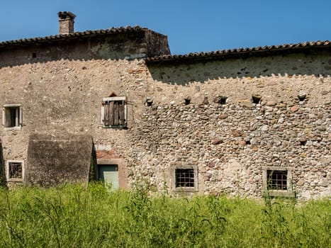 Old abandoned stone house in the Italian hills.