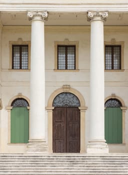 Detail of the entrance of a Venetian villa with white stone columns.