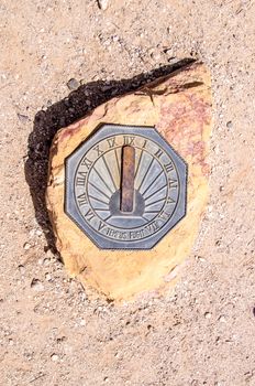 Metal Sun dial on rock in the Arizona desert