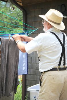 Country gentleman doing his laundry outside.