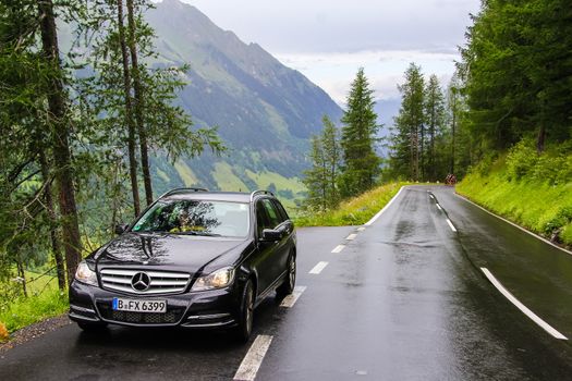 TYROL, AUSTRIA - JULY 29, 2014: Black estate car Mercedes-Benz W204 C180 at the Grossglockner High Alpine road.