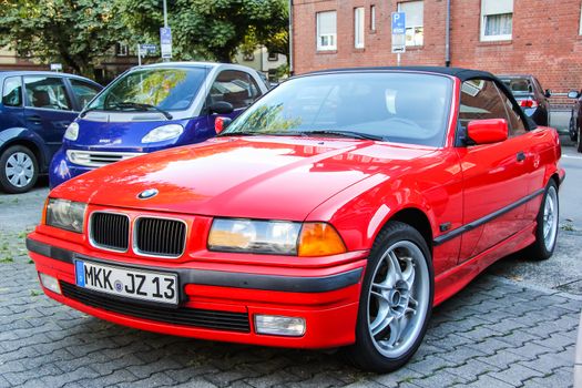 FRANKFURT AM MAIN, GERMANY - SEPTEMBER 13, 2013: Motor car BMW E36 3-series at the city street.