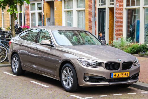 AMSTERDAM, NETHERLANDS - AUGUST 10, 2014: Motor car BMW F34 3-series GT at the city street.