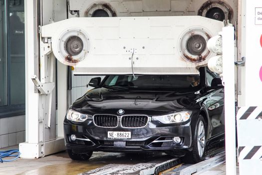 MONTREUX, SWITZERLAND - AUGUST 6, 2014: Motor car BMW F30 3-series at the car wash service station.