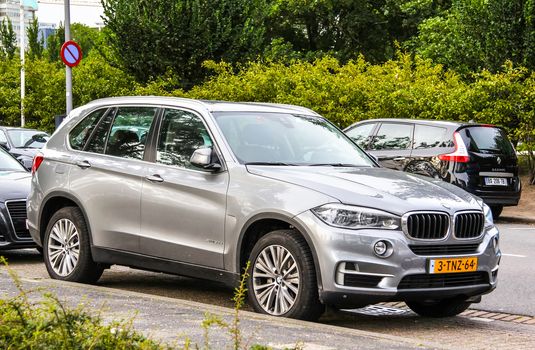 ROTTERDAM, NETHERLANDS - AUGUST 9, 2014: Modern crossover BMW F15 X5 at the city street.