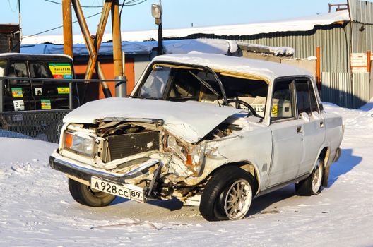 NOVYY URENGOY, RUSSIA - MARCH 16, 2013: Damaged motor car Lada 2107 Zhiguli at the city street.