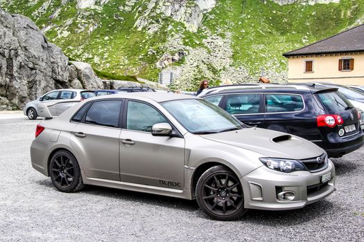 GOTTHARD PASS, SWITZERLAND - AUGUST 5, 2014: Motor car Subaru Impreza at the high Alpine mountain road.