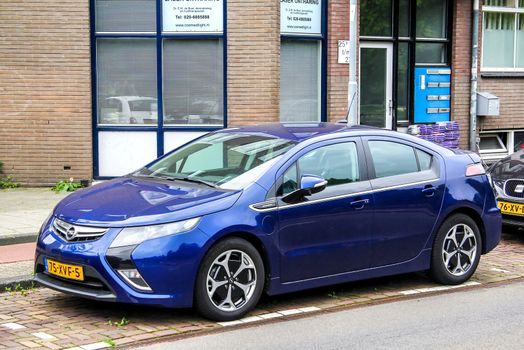 AMSTERDAM, NETHERLANDS - AUGUST 10, 2014: Electric car Opel Ampera at the city street.