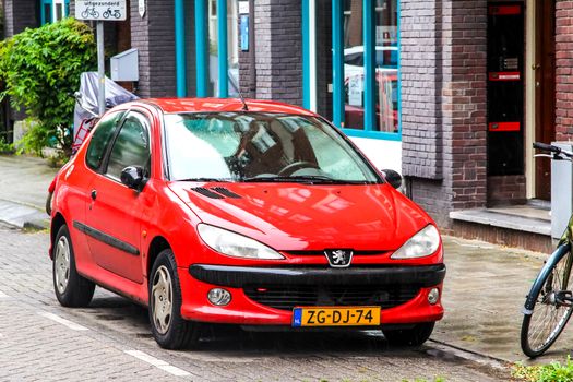 AMSTERDAM, NETHERLANDS - AUGUST 10, 2014: Motor car Peugeot 206 at the city street.