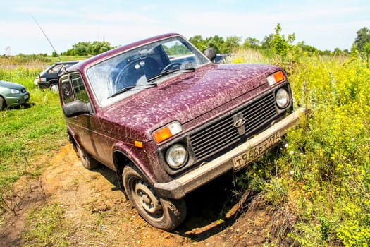 CHELYABINSK, RUSSIA - JUNE 28, 2014: Motor car Lada Niva at the gravel road.