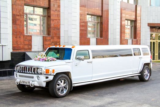 NOVYY URENGOY, RUSSIA - AUGUST 31, 2012: White limousine Hummer H3 at the city street.