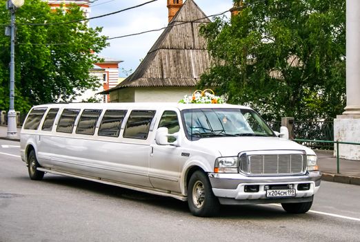 MOSCOW, RUSSIA - JULY 9, 2011: White limousine Ford Excursion at the city street.