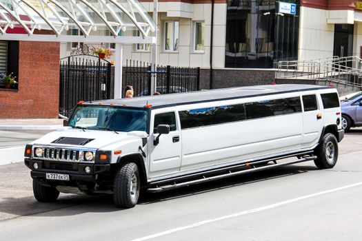 CHEBOKSARY, RUSSIA - JULY 19, 2014: White limousine Hummer H2 at the city street.