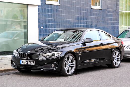 DRESDEN, GERMANY - JULY 20, 2014: Black sports car BMW F32 4-series at the city street.