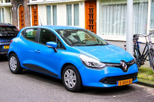 AMSTERDAM, NETHERLANDS - AUGUST 10, 2014: Motor car Renault Clio at the city street.