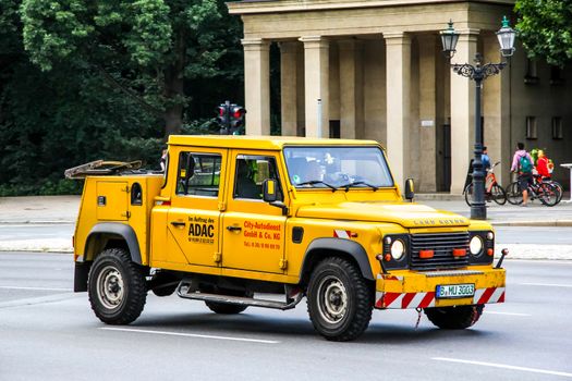 BERLIN, GERMANY - AUGUST 15, 2014: Tow truck Land Rover Defender at the city street.