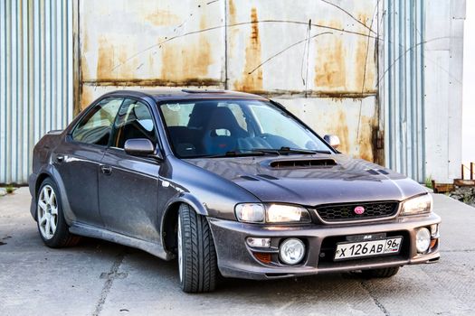 NOVYY URENGOY, RUSSIA - JULY 4, 2014: Motor car Subaru Impreza at the city street.