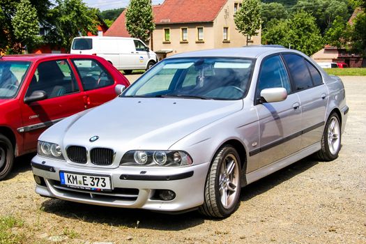 KOENIGSBRUECK, GERMANY - JULY 20, 2014: Motor car BMW E39 5-series at the town street.