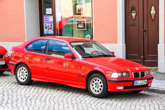KOENIGSBRUECK, GERMANY - JULY 20, 2014: Motor car BMW E36/5 3-series Compact at the town street.