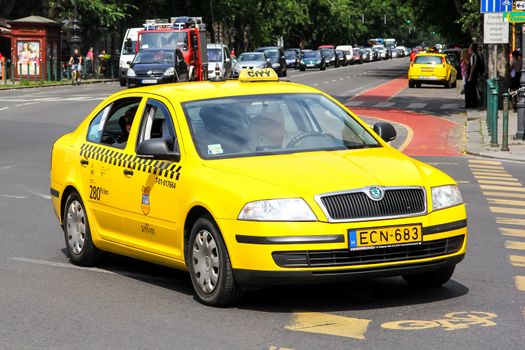 BUDAPEST, HUNGARY - JULY 23, 2014: Yellow taxi car Skoda Octavia at the city street.