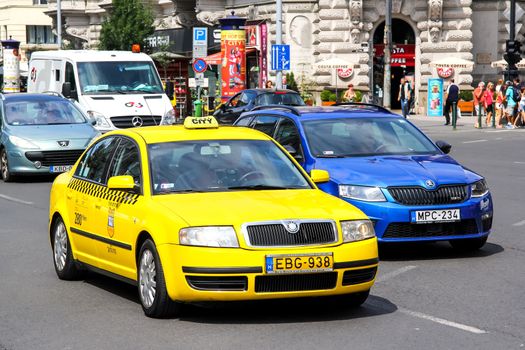 BUDAPEST, HUNGARY - JULY 23, 2014: Yellow taxi car Skoda Superb at the city street.