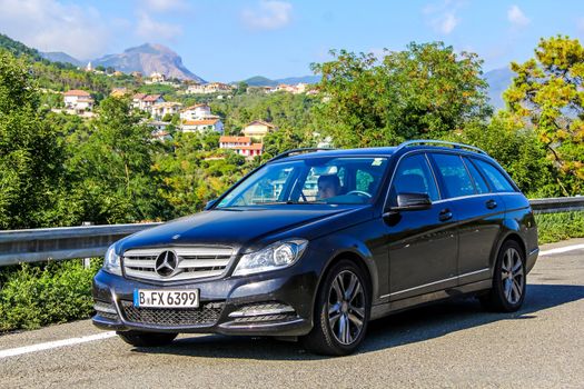 TUSCANY, ITALY - AUGUST 1, 2014: Motor car Mercedes-Benz W204 C180 at the interurban freeway.